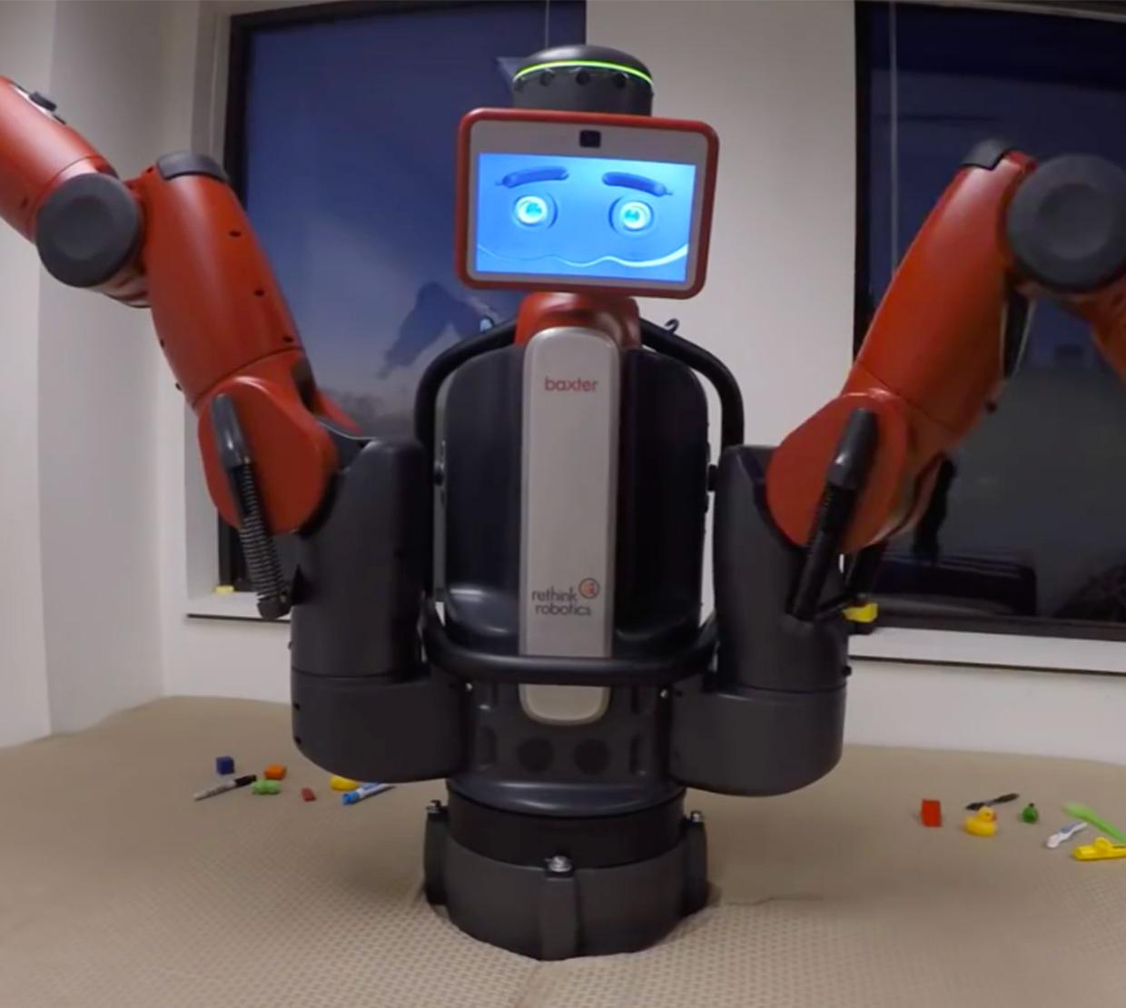Robot with long arms sitting on office table