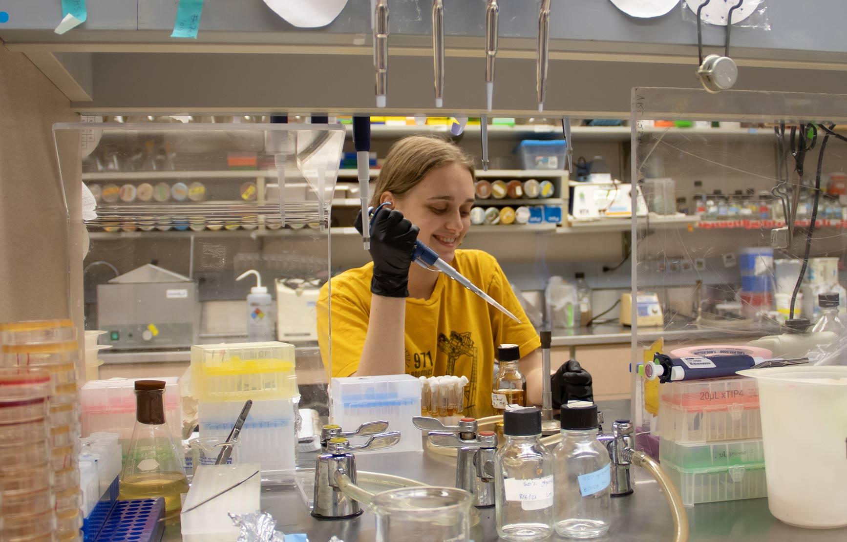 A student working with samples in a lab.